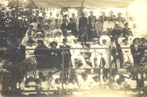 Dignitaries on platform. 1st. row: from left-4th Queen Lili‘uokalani; 5th Governor Pinkham, 9th Sanford Dole. 2nd row: couple at end: Harriet Buchanan Tillsy, Lt. B. F. Tillsy, Jr. Collection: General Photograph Collection Call Number: People. Lili`uokalani. 1894-1917. Folder 5. Location: Bishop Museum Archives Image from Bishop Museum Archives, Honolulu, Hawaii. Images are not to be re-used without permission.