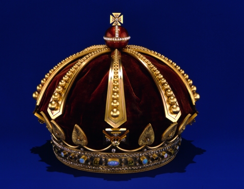 One of two crowns ordered from England in 1882 by King Kalākaua and Queen Kapi`olani. Gold, diamonds, opals, emeralds, rubies, pearls, carbuncle, enamel, kukui nut, velvet, silk. Photographer: Seth Joel From: Rose, Roger. Hawai‘i: The Royal Isles. Honolulu: Bishop Museum Press, 1980, frontispiece, no. 252. Artifact Number: HH 101 Image from Bishop Museum Archives, Honolulu, Hawaii. Images are not to be re-used without permission.
