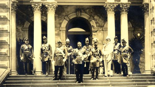 King Kalākaua and staff on ‘Iolani Palace steps, Hawai‘i, ca. 1890. L to R: James Boyd, Col.Curtis Iaukea, Chas. H. Judd, E.W. Purvis, King Kalākaua, Geo. McFarlane, Governor J.O. Dominis, A.B. Hally, John D. Holt and Antone Rosa. Photograph by J.J. Williams. Call Number: G. & P. Monarchy. Kalākaua, 1874-1891 Image from Bishop Museum Archives, Honolulu, Hawaii. Images are not to be re-used without permission.