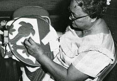 Quilting instruction with Auntie Debbie Kepola Kakalia at Atherton Hālau, Bishop Museum. 1981. Photo by Ben Patnoi. Collection: General Photograph Collection Call Number: E.C. Hawaiian. Art. Quilting. Artifact Number: CF 75148 Location: Bishop Museum Archives Image from Bishop Museum Archives, Honolulu, Hawaii. Images are not to be re-used without permission.