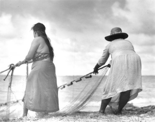 Two Hawaiian women pulling in fish net (hukilau); Hawai‘i, ca. 1934-1937. Photographer: N.R. Farbman. Collection: N.R. Farbman Collection Call Number: Farbman 9.3 Image from Bishop Museum Archives, Honolulu, Hawaii. Images are not to be re-used without permission.