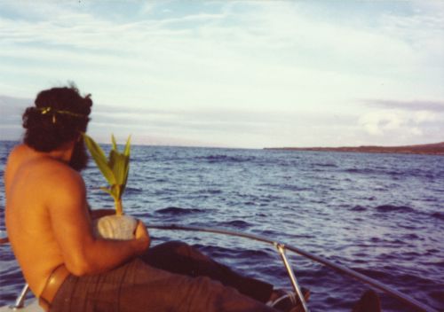 Protect Kaho`olawe `Ohana approaching the Island of Kaho`olawe by boat, Hawai`i; George Helm holding a coconut to plant, 1977. Collection: General Photograph Collection Call Number: Geography. Kaho`olawe. Protect Kaho`olawe `Ohana. Location: Bishop Museum Archives Image from Bishop Museum Archives, Honolulu, Hawaii. Images are not to be re-used without permission.