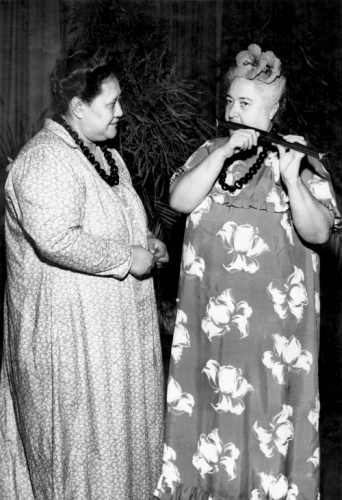 Mrs. Mary Kawena Pukui playing the ‘ūkēkē with Mrs. Timothy (Rosalie) Montgomery; Hawai‘i, 1950. Collection: General Photograph Collection Call Number: E.C. Hawaiian. Music. Musicians. Instruments. Location: Bishop Museum Archives Image from Bishop Museum Archives, Honolulu, Hawaii. Images are not to be re-used without permission.
