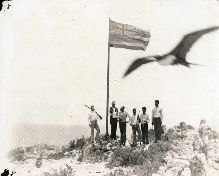 Ceremony to annex Mokumanamana (Necker Island) for the Republic of Hawaii. From left to right: Gregory, Freeman, three sailors. This ceremony took place atop what was later called "Annexation Hill" the highest point on Mokumanamana. Photo by Ben H. Norton, Chief Engineer of the Iwalani. Collection: General Photograph Collection Call Number: Geography. Hawai‘i. Necker Island, folder 2. Artifact Number: SP 117618 Location: Bishop Museum Archives Image from Bishop Museum Archives, Honolulu, Hawaii. Images are not to be re-used without permission.