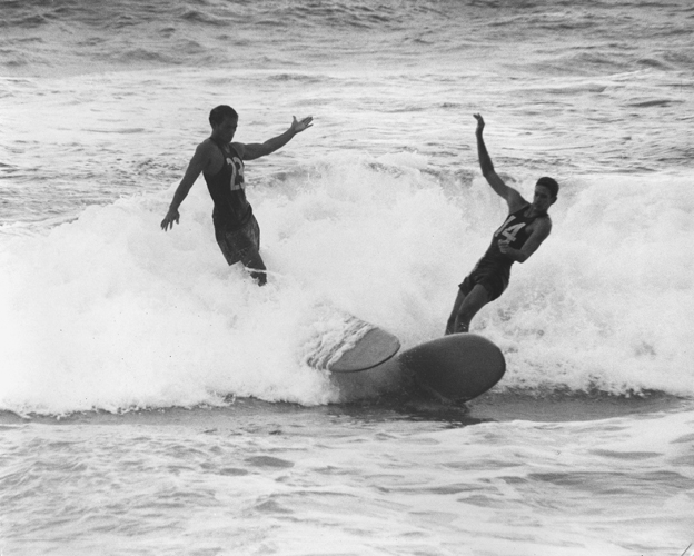 Two surfers in the Makaha International Surfing Championship; Makaha, O‘ahu. ca. 1960. Collection: Laurence Hata Collection Call Number: Hata. Recreation. Sports. Surfing. Artifact Number: I 91298.5 Image from Bishop Museum Archives, Honolulu, Hawaii. Images are not to be re-used without permission.