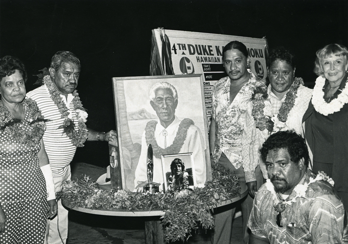 The Aikau family and Nadine Kahanamoku at the 14th Duke Kahanamoku Surfing Classic and memorial for Eddie Aikau, 1978. Collection: Kahanamoku Collection Call Number: Kahanamoku. Recreation. Sports. Surfing. Location: Bishop Museum Archives Image from Bishop Museum Archives, Honolulu, Hawaii. Images are not to be re-used without permission.