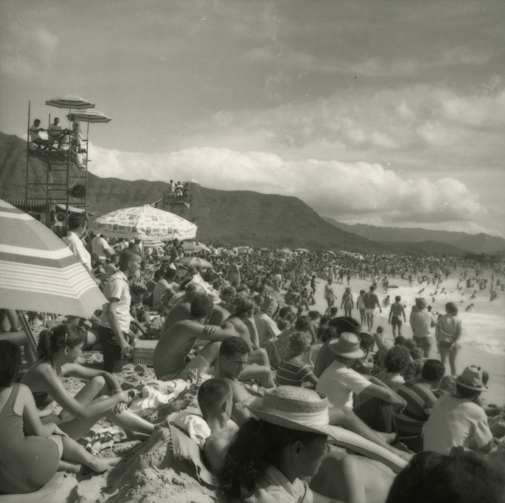 Spectators at Makaha Beach watching a surf competition, 1958. Collection: Laurence Hata Collection Call Number: Hata. Recreation. Sports. Surfing. Artifact Number: H_91769_9 Image from Bishop Museum Archives, Honolulu, Hawaii. Images are not to be re-used without permission.