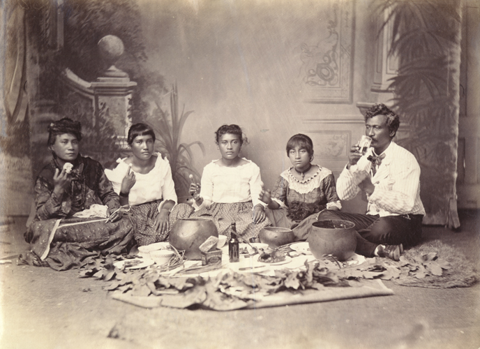 Studio portrait of Hula master Ioane and family eating poi, ca. 1885. Call Number: E.C. Hawaiian. Domestic Life. Foods. Poi, folder 2 Artifact Number: SP 44724 Image from Bishop Museum Archives, Honolulu, Hawaii. Images are not to be re-used without permission.