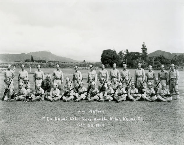 October 22, 1944 A unique part of Hawai‘i during World War II was the formation of quasi-military militias. These men wore uniforms and trained with weapons, but were not actually part of any branch of the U.S. military forces. The group in this photo, the Kaua‘i Volunteers, were all Filipino agricultural workers. While the general intention of the militias was to assist with war activities as required, in this particular case the additional benefit was to channel the anger that Filipino men felt about the invasion and occupation of their homeland by Japan. This defused possible conflicts between these men and their Japanese coworkers and neighbors on Kaua‘i. Collection: General Photograph Collection Call Number: Military. War. WWII. folder 1. Artifact Number: SP 96451 Accession Number: 1977.446 Location: Bishop Museum Archives Image from Bishop Museum Archives, Honolulu, Hawaii. Images are not to be re-used without permission.