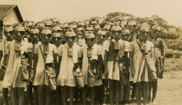 Poison gas had been used on the European battlegrounds of World War I. It was considered such a horrific weapon that it had later been outlawed by international treaties. Even so, most countries prepared for possible poison gas attacks in World War II. In Hawaiʻi, every person was issued a gas mask, which was supposed to be carried at all times. Most people stopped doing so within a few months since the masks were heavy and awkward to carry. And fortunately, the masks were never needed. Collection: General Photograph Collection Call Number: Military. War. WWII. folder 1. Artifact Number: SP_201222 Accession Number: 2002.165.006 Location: Bishop Museum Archives Image from Bishop Museum Archives, Honolulu, Hawaii. Images are not to be re-used without permission.