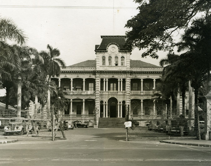 ‘Iolani Palace was the seat of government in 1941, containing the Governor’s office as well as the Legislature. When the military seized control of the government on Dec. 7, military officers moved in and the Palace grounds were quickly surrounded by barbed wire (as this photo shows). Martial law was in effect until 1944, in a takeover which was unprecedented in American history. During this period, laws were created simply by proclamations, and civilians were subject to military courts and legal punishments. Collection: General Photograph Collection Call Number: 1998.346, page 39 Location: Bishop Museum Archives Image from Bishop Museum Archives, Honolulu, Hawaii. Images are not to be re-used without permission.